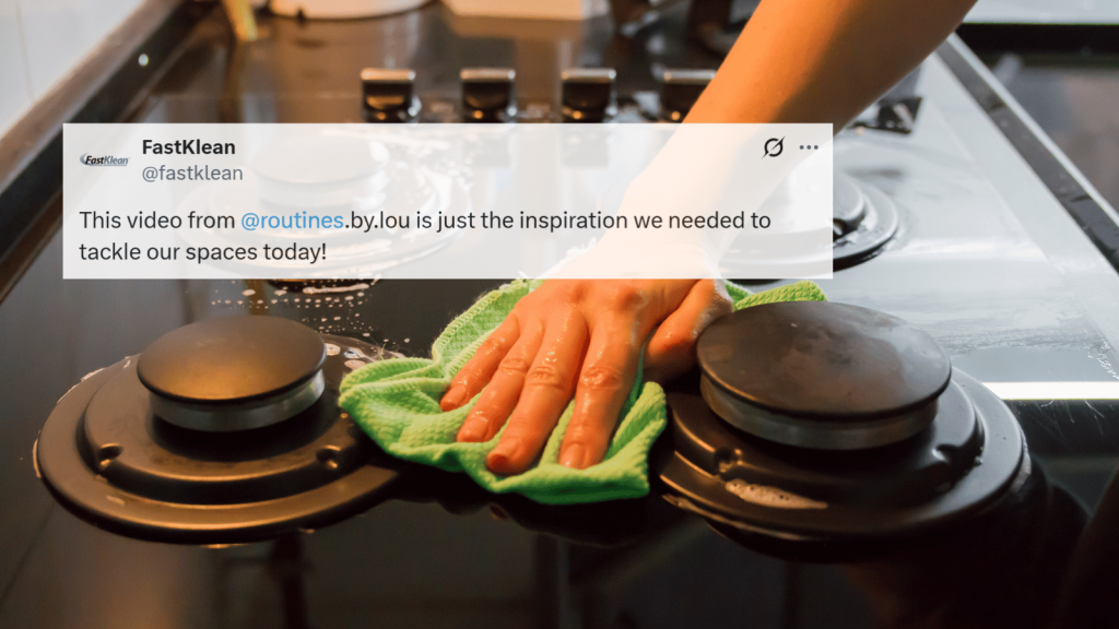 A tweet overlay on a close-up of someone scrubbing a stovetop with a green microfiber cloth, cleaning around the burners with suds visible.