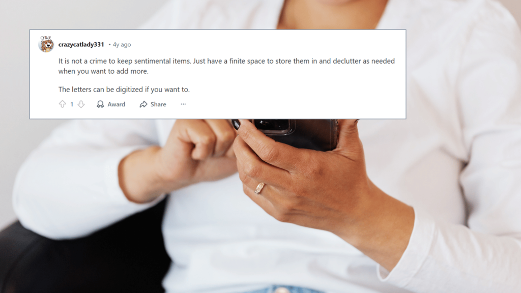 A Reddit comment from user “crazycatlady331” explaining that sentimental items are fine as long as they’re stored with limits, displayed over a background photo of a woman holding a smartphone.