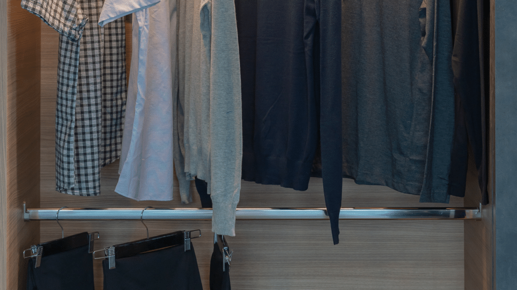 Closet with double hanging rods for shirts and pants, showing simple closet fixes to maximize hanging space.