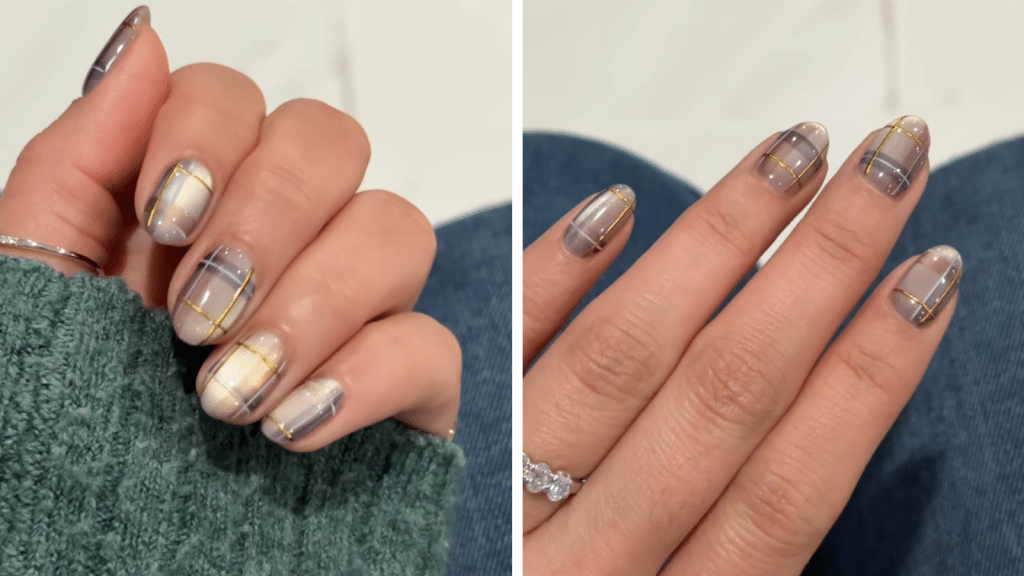 Short rounded nails with neutral magnetic gradients and fine plaid linework in navy, white, and gold striping. The heritage-inspired pattern echoes old money Christmas nails—classic, polished, and refined—while fitting into the soft, elegant Christmas nails category.