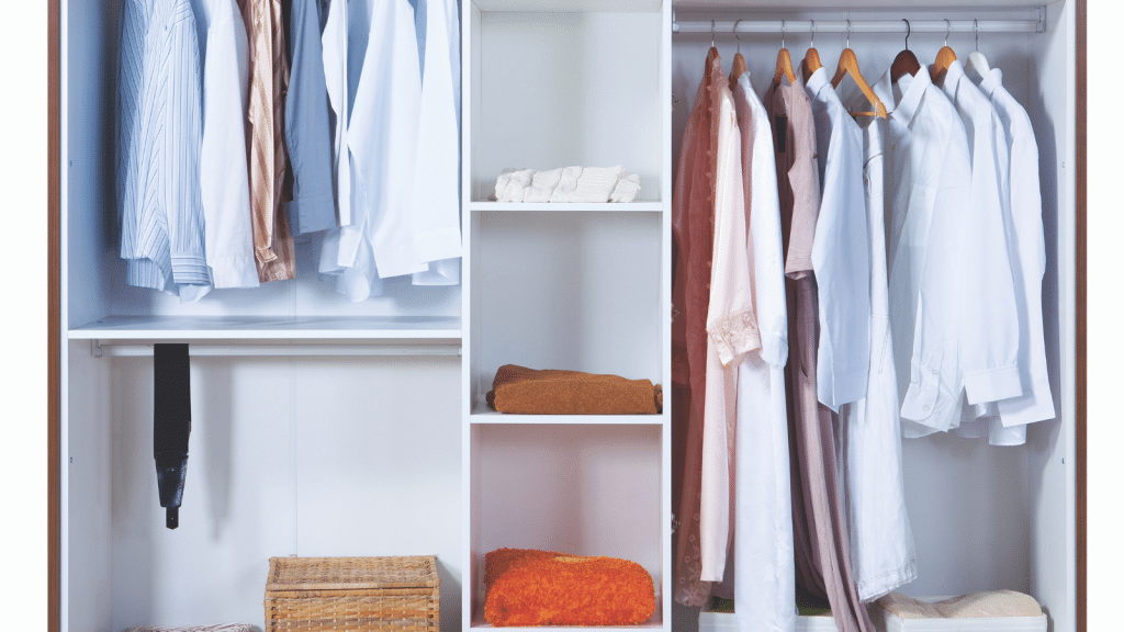 Small walk-in closet with hanging clothes, shelves, and open floor space, highlighting uncluttered small walk-in closet ideas.