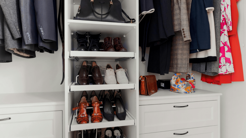 White closet shelves with neatly arranged shoes and hanging clothes, demonstrating small walk-in closet ideas for shoe storage.