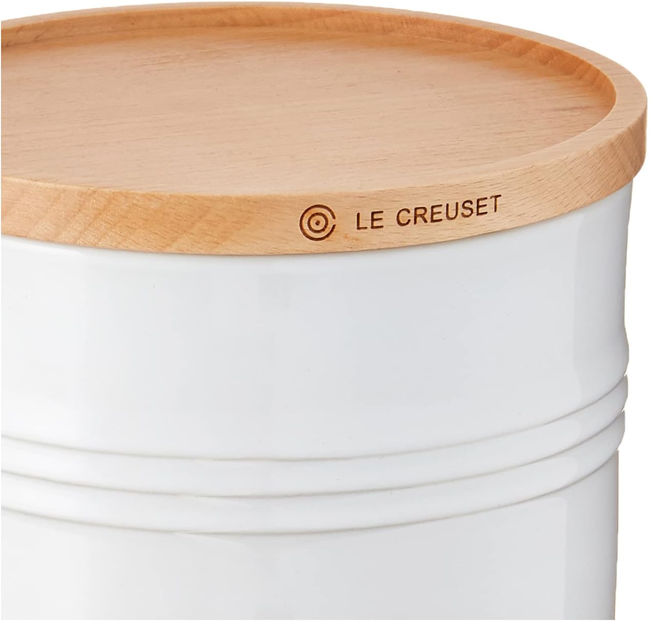 Le Creuset white stoneware canister with acacia wood lid on kitchen counter